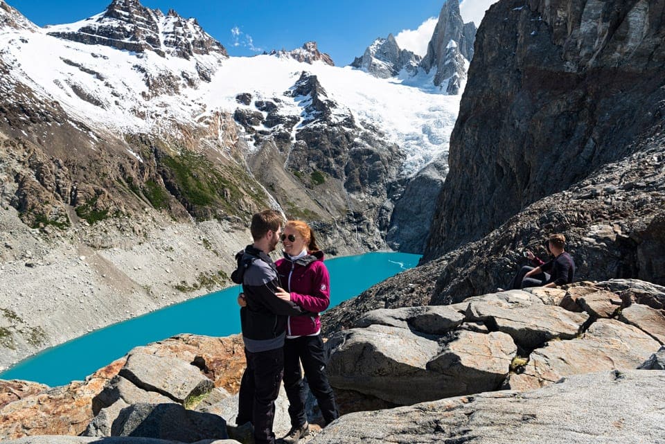 a couple with the laguna Sucia and moutnains in the background