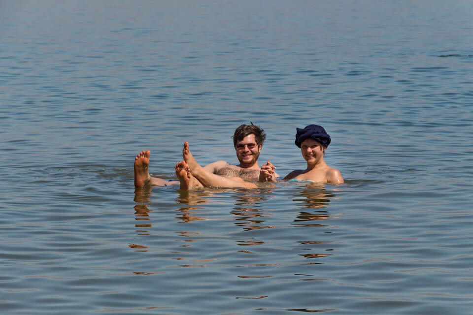 a couple floating on the Dead Sea