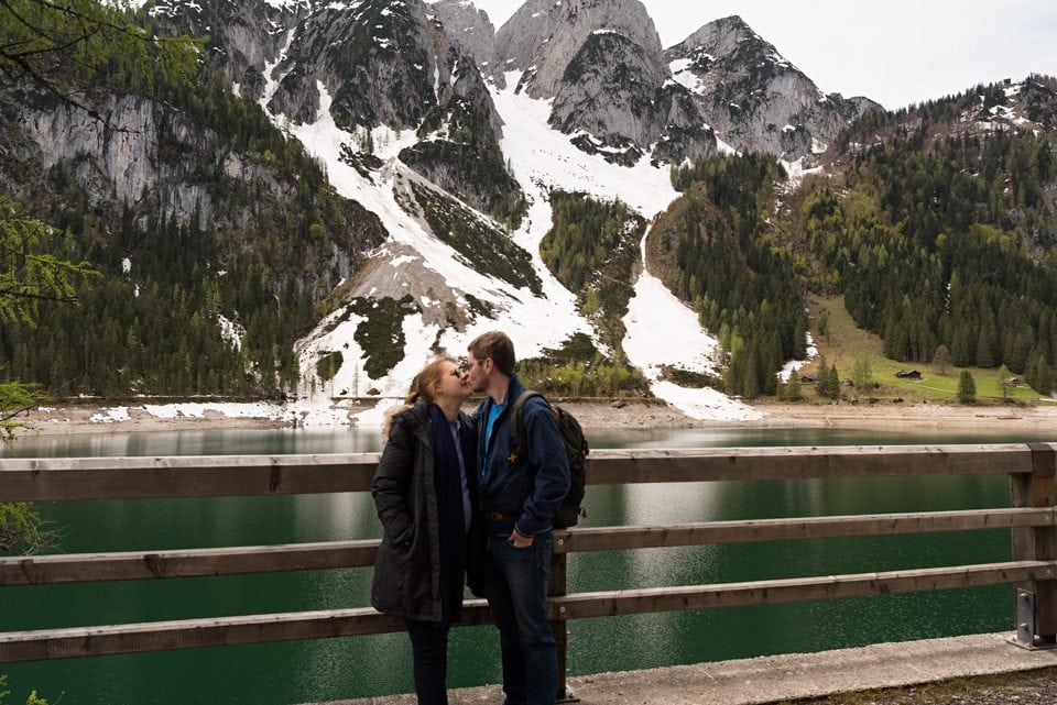 a couple kissing by lake Gosausee during a babymoon in Austria