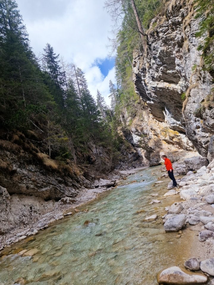 me admiring the turquoise waters of the boite river in the gorge in dolomites italy