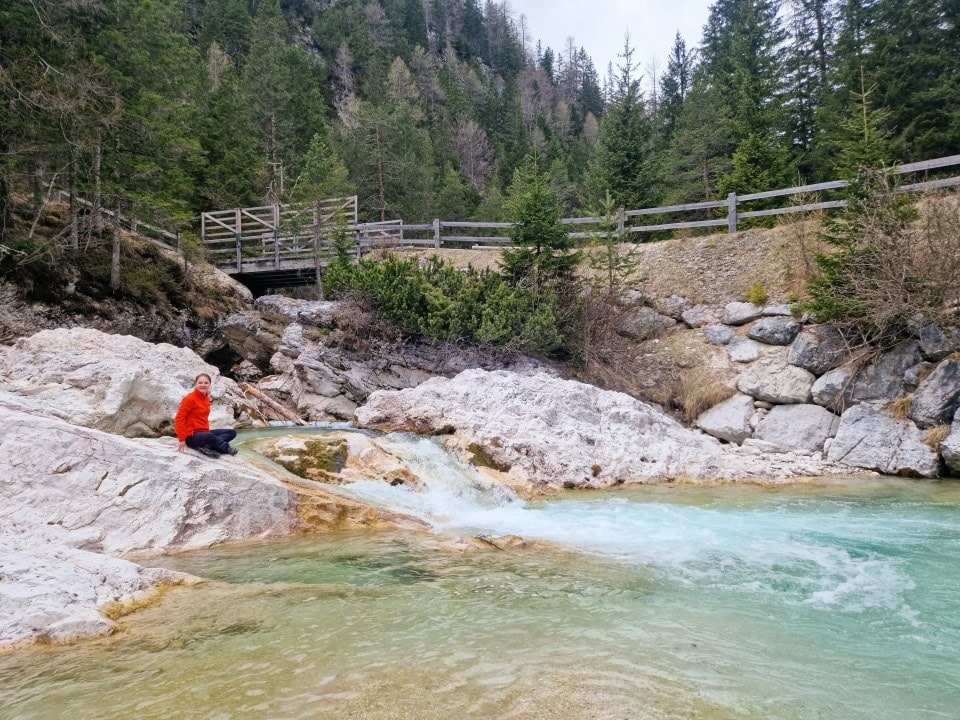 a waterfall and a bridge on river boite in dolomites italy