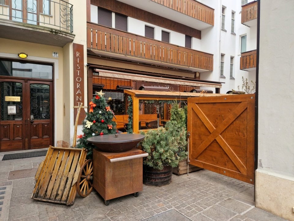 a restaurant with Christmas decorations still on in april in dolomites italy