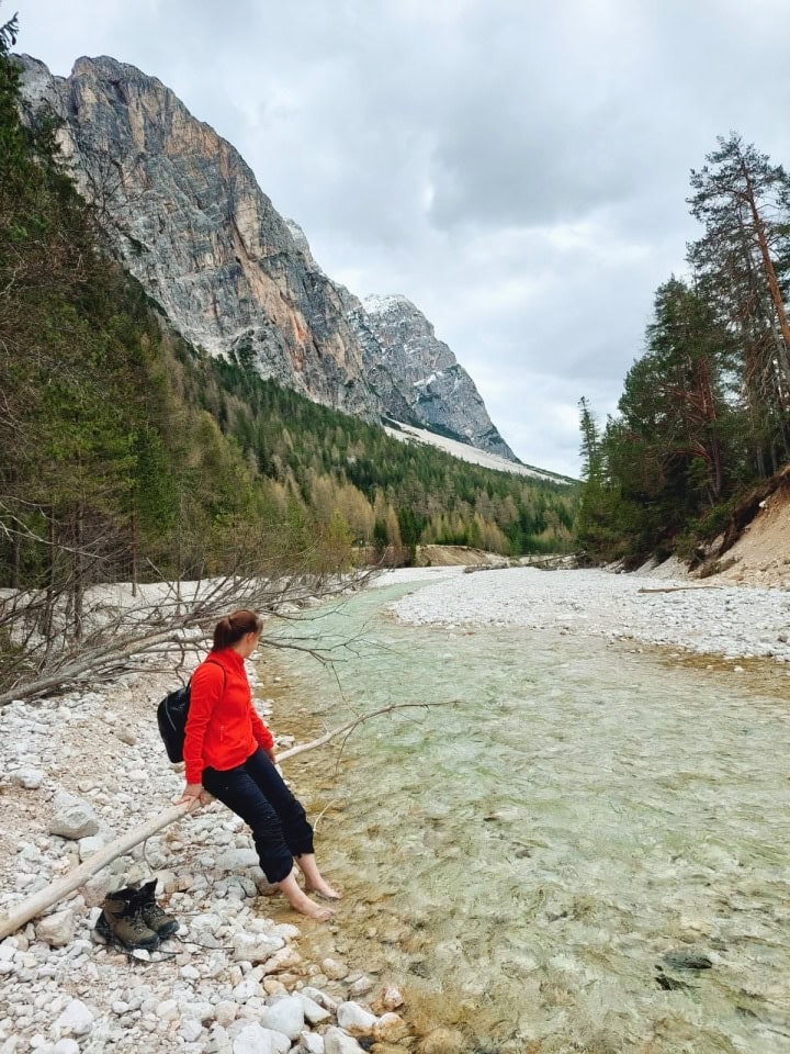 resting my feet in the crazy cold turquoise waters of the boite river in dolomites italy