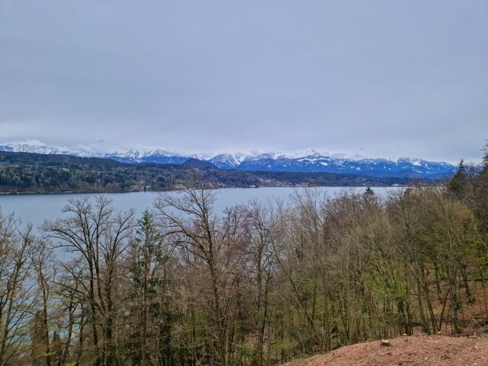 lake worthersee in austria on the way to dolomites in italy with snowy mountains in the background