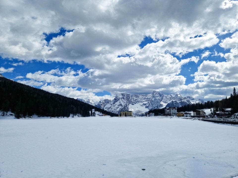 a view of a very snowy lake misurina with very snowy mountains in the background in dolomites italy