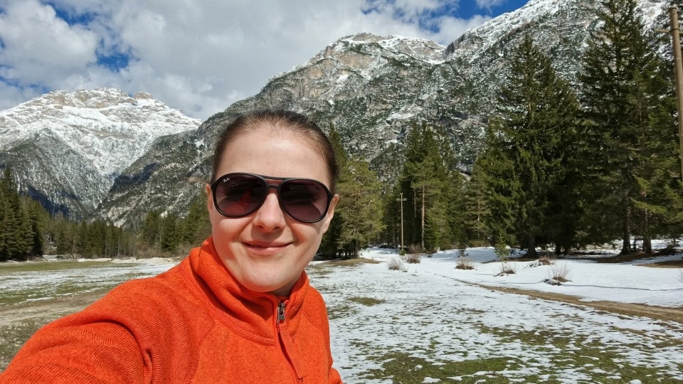 a selfie with snowy mountains in the background in dolomites italy