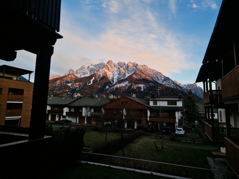 a sunset view from our hotel in dobbiaco dolomites italy - the sun is colouring the mountains orange