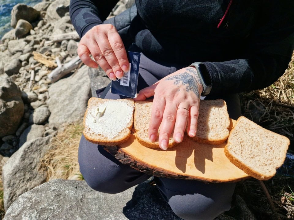 preparing sandwiches by lake valdaora, dolomites, italy