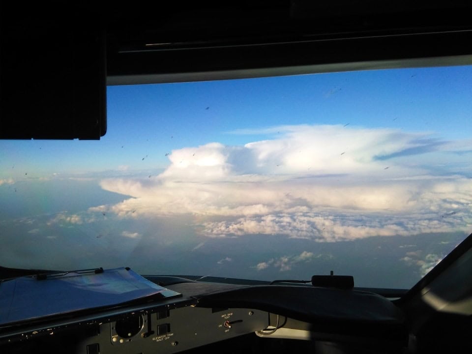 a thunderstorm cloud as seen from a cockpit of an airplane