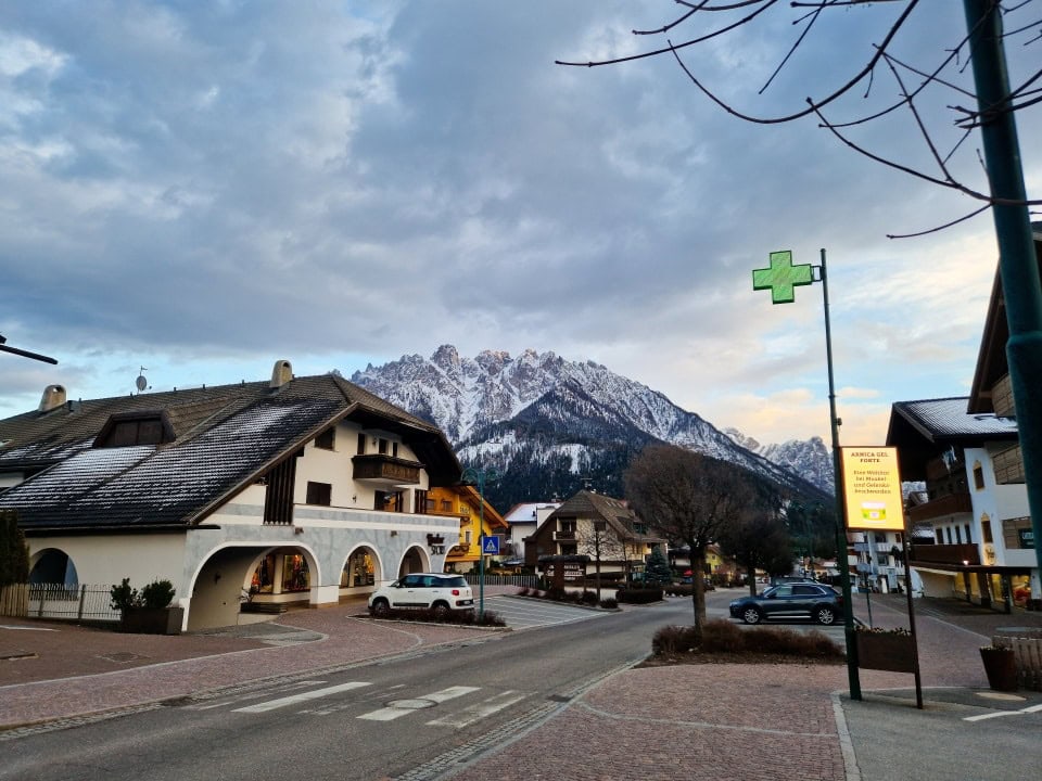 view of a street and mountains in dobbiaco/toblach italy dolomites