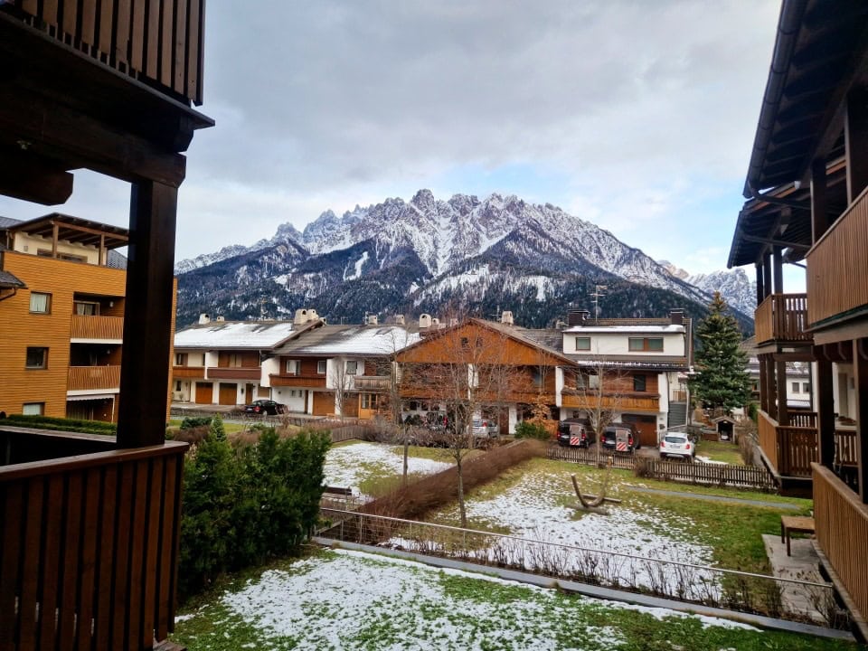 view from the hotel in dobbiaco/toblach of the snowy mountains in italy dolomites in april