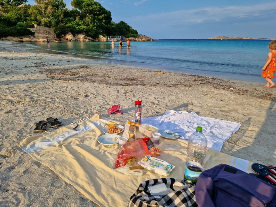 a sunset picnic on a beach in sardinia italy