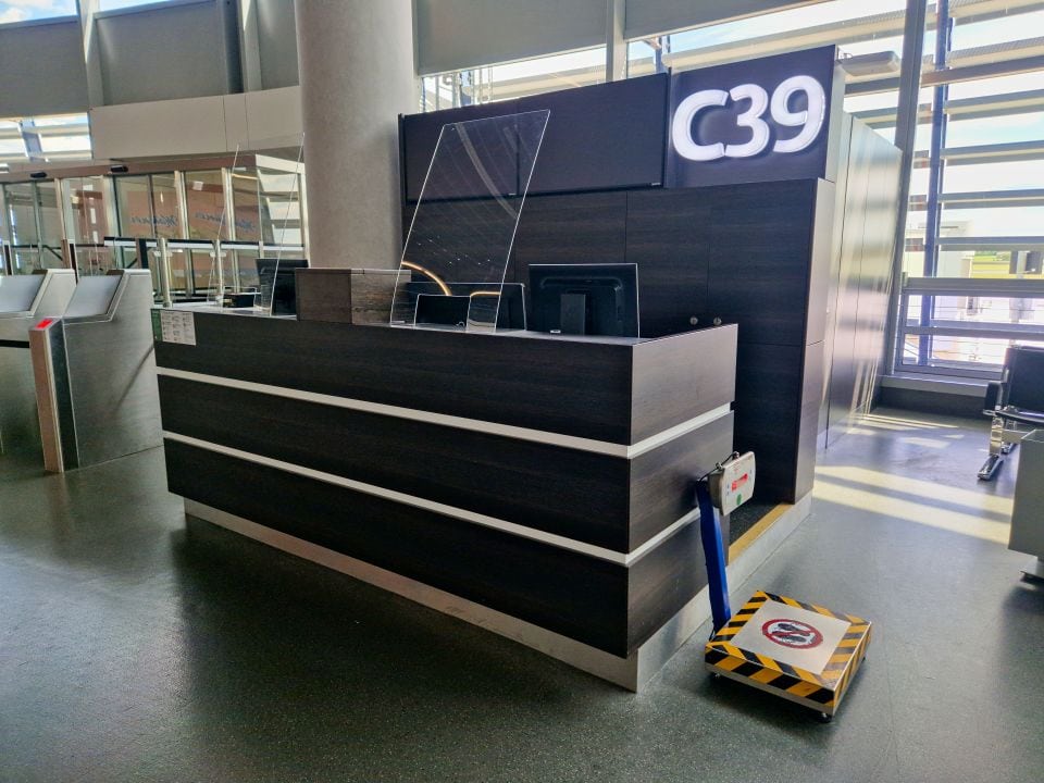 a black gate with a shining number C39 and a luggage scale in vienna airport